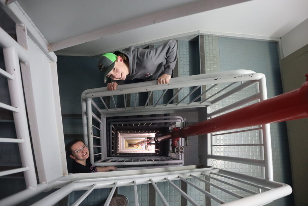 Two students climb the steps to reach the air traffic control tower.