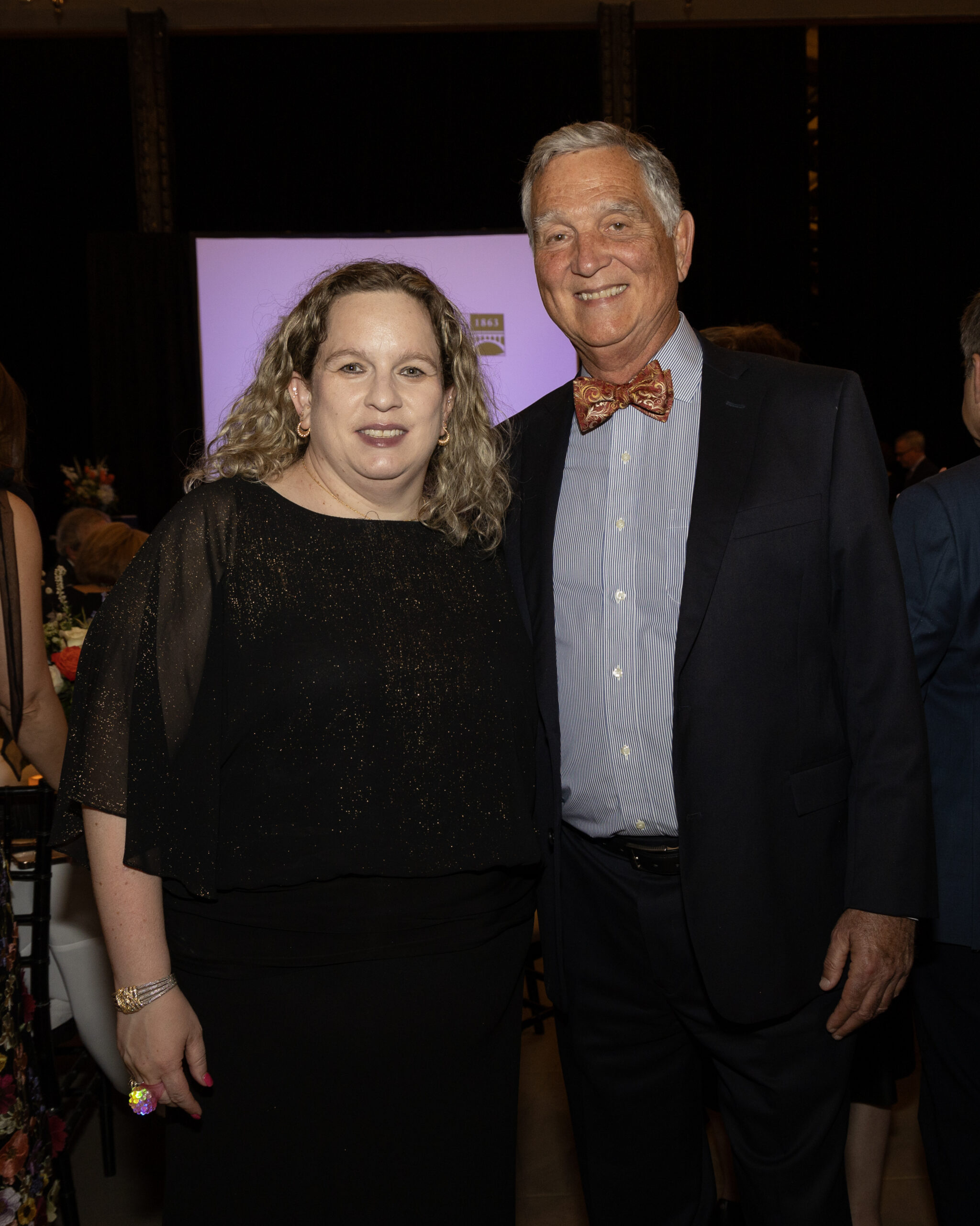 Guests smiling at the 2025 Illumination Gala.