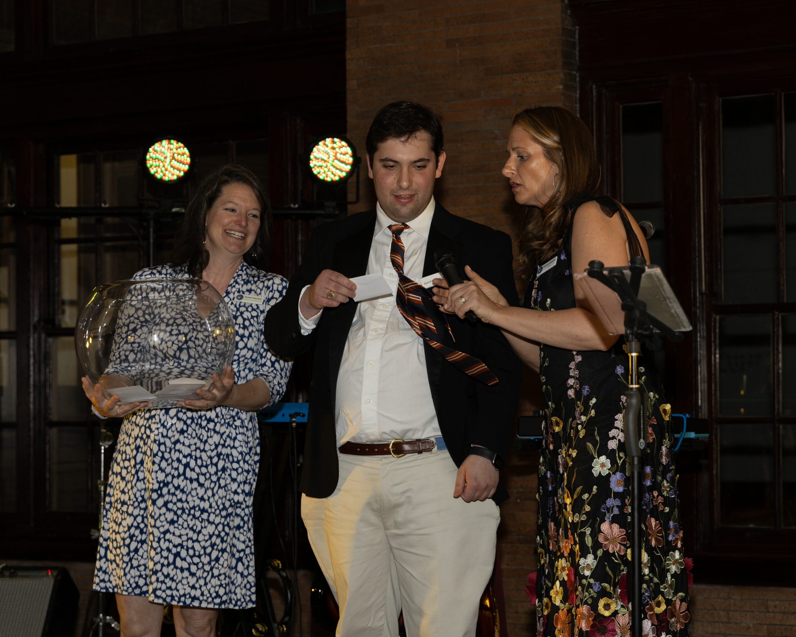 A Northstar Alum draws the winner of the Lucky Envelope game.