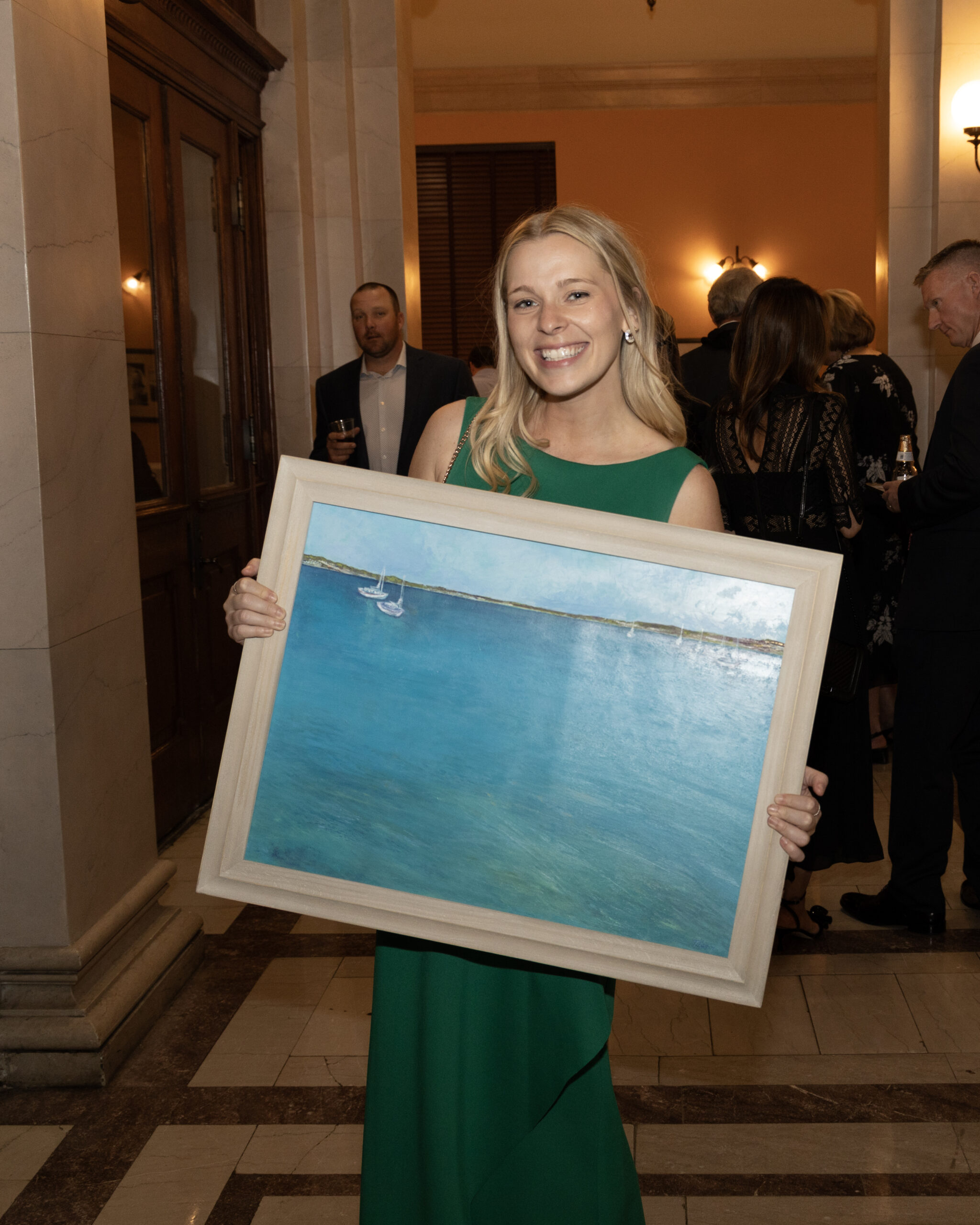 The winner of a silent auction bid with her art piece.