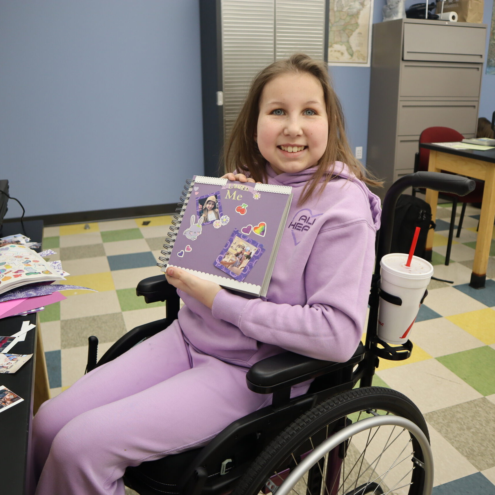A student shows off their scrapbook.