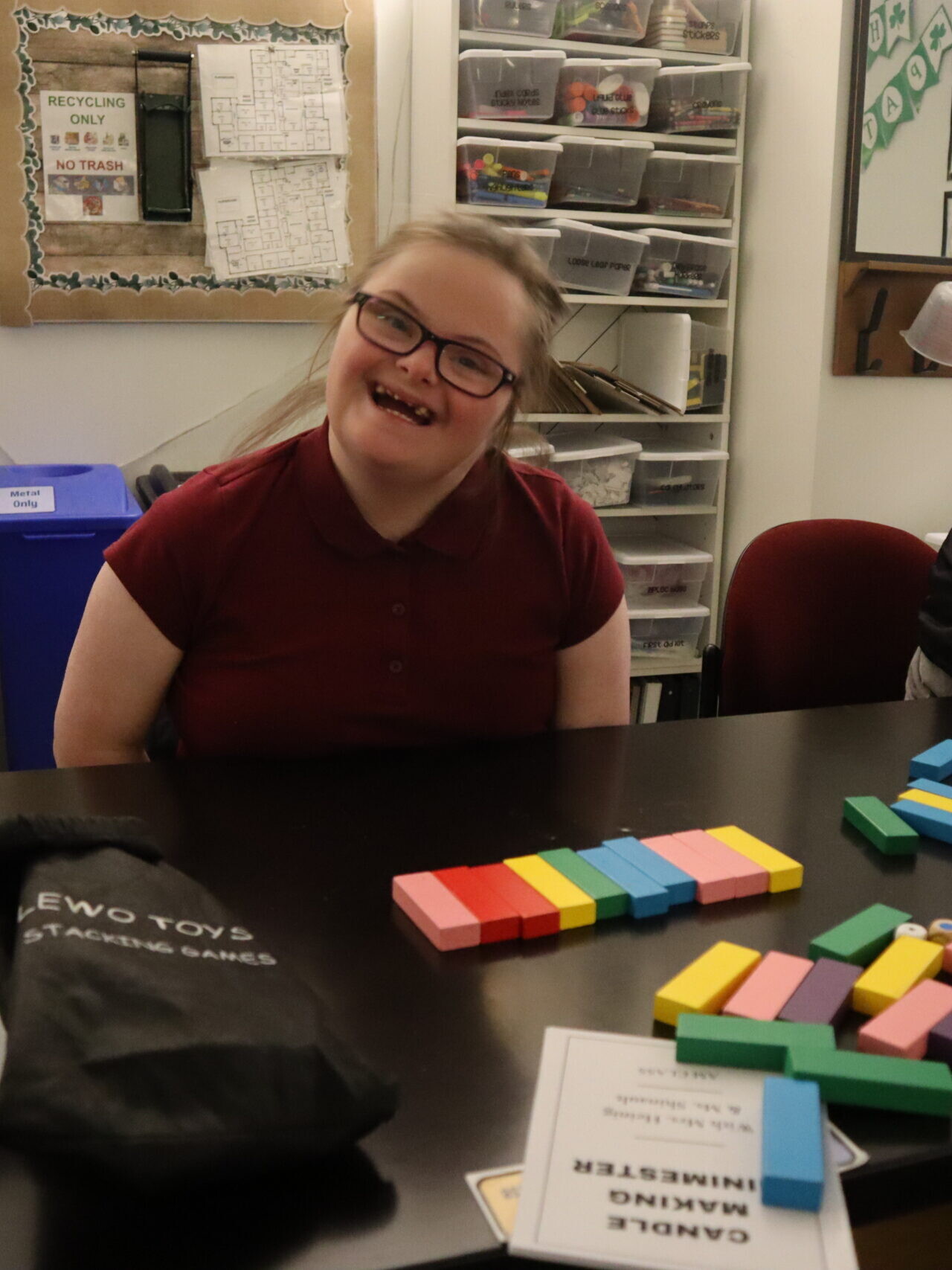 A student smiles at their desk in Science class.