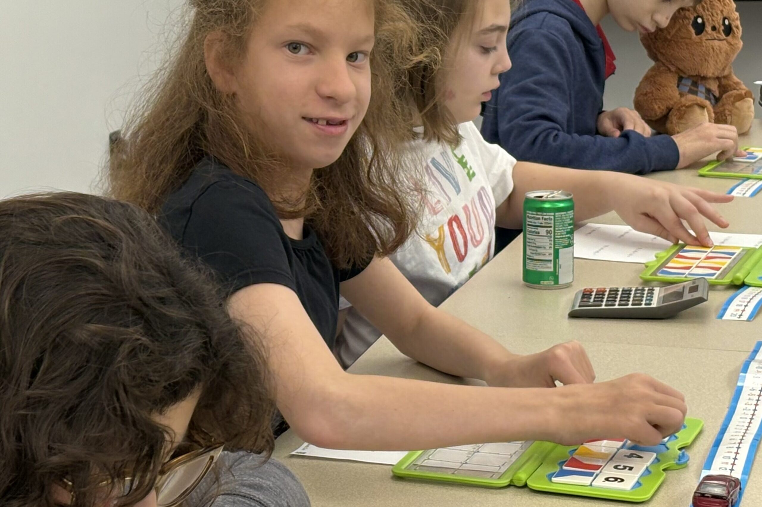 Middle school students use manipulatives during class.