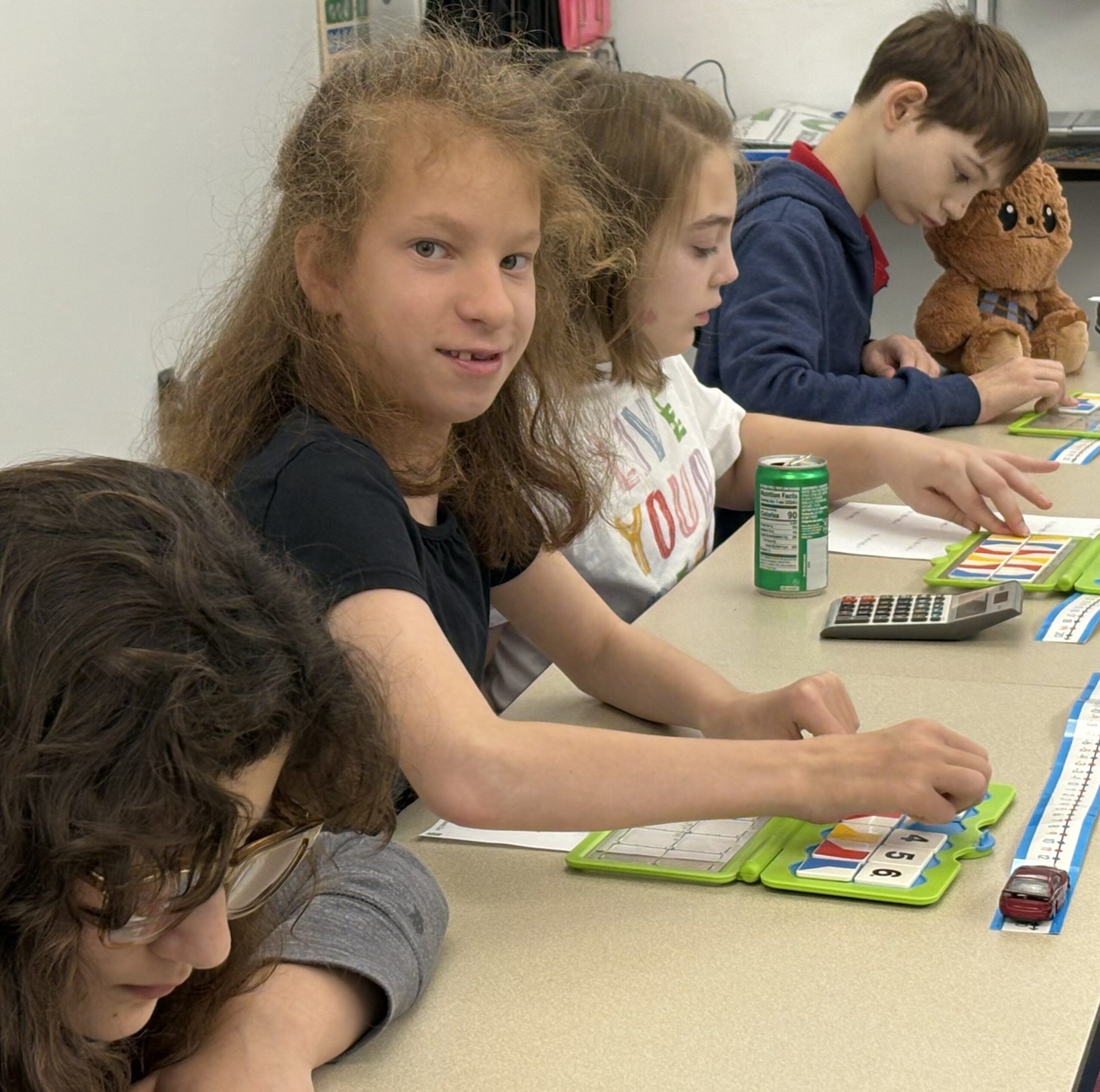 Middle school students use manipulatives during class.