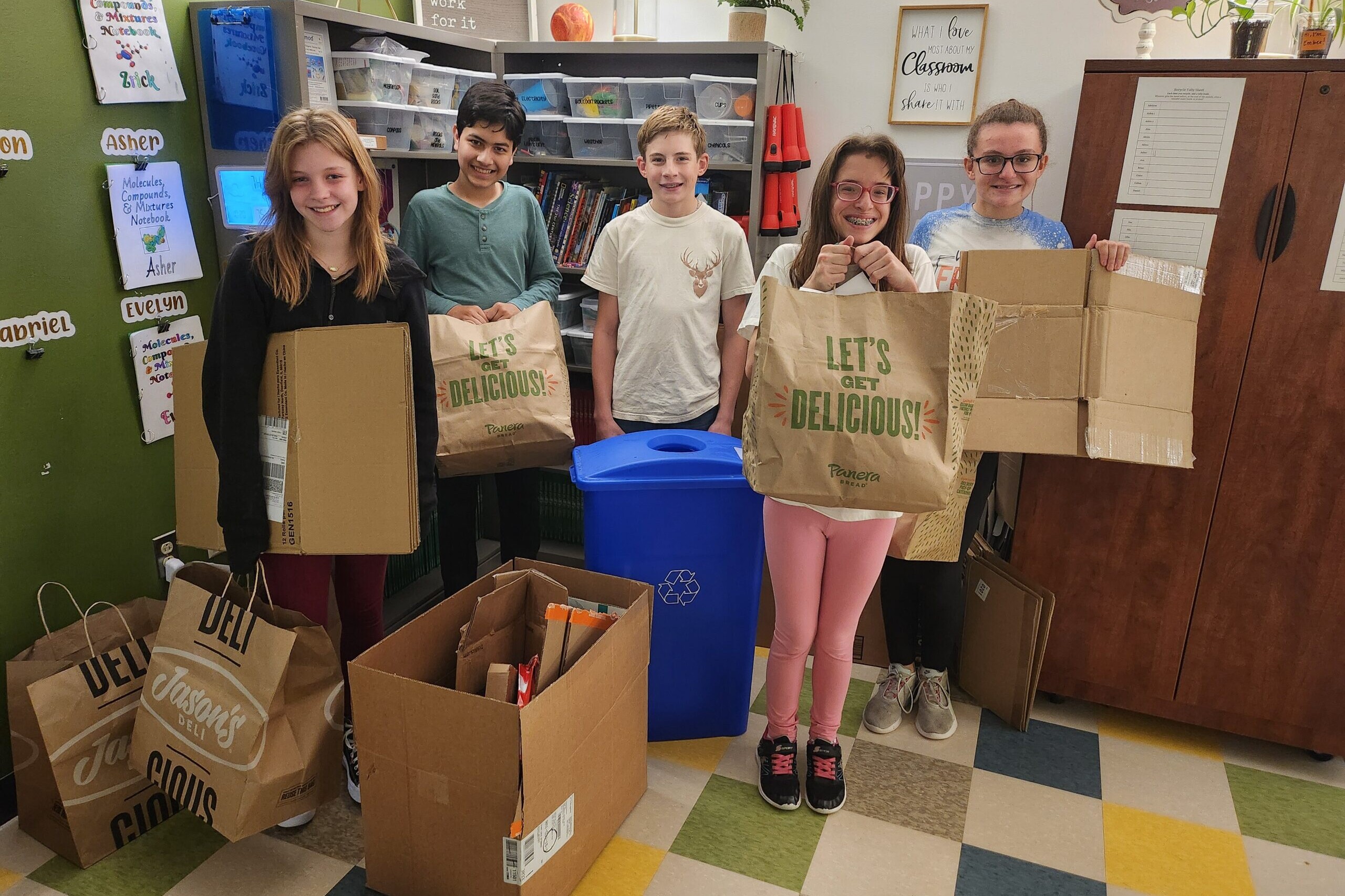 Students pose with recyclable materials they have collected and sorted from across campus.