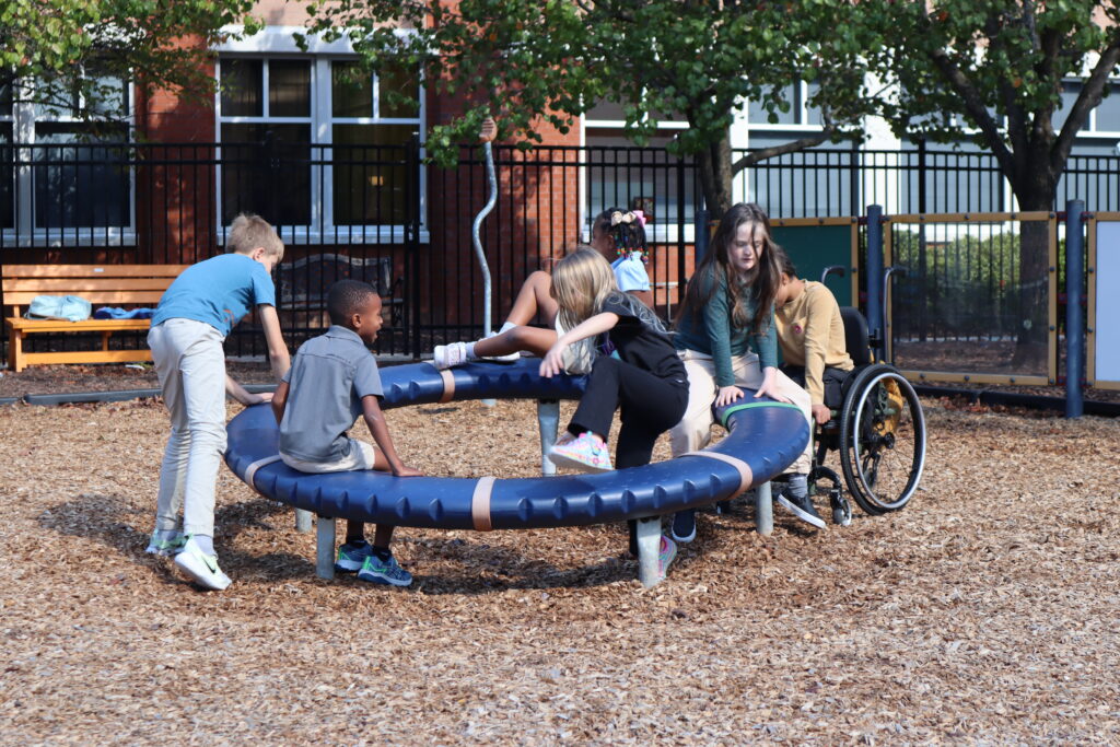 Recess Play Lower School students play on adaptive playground equipment.