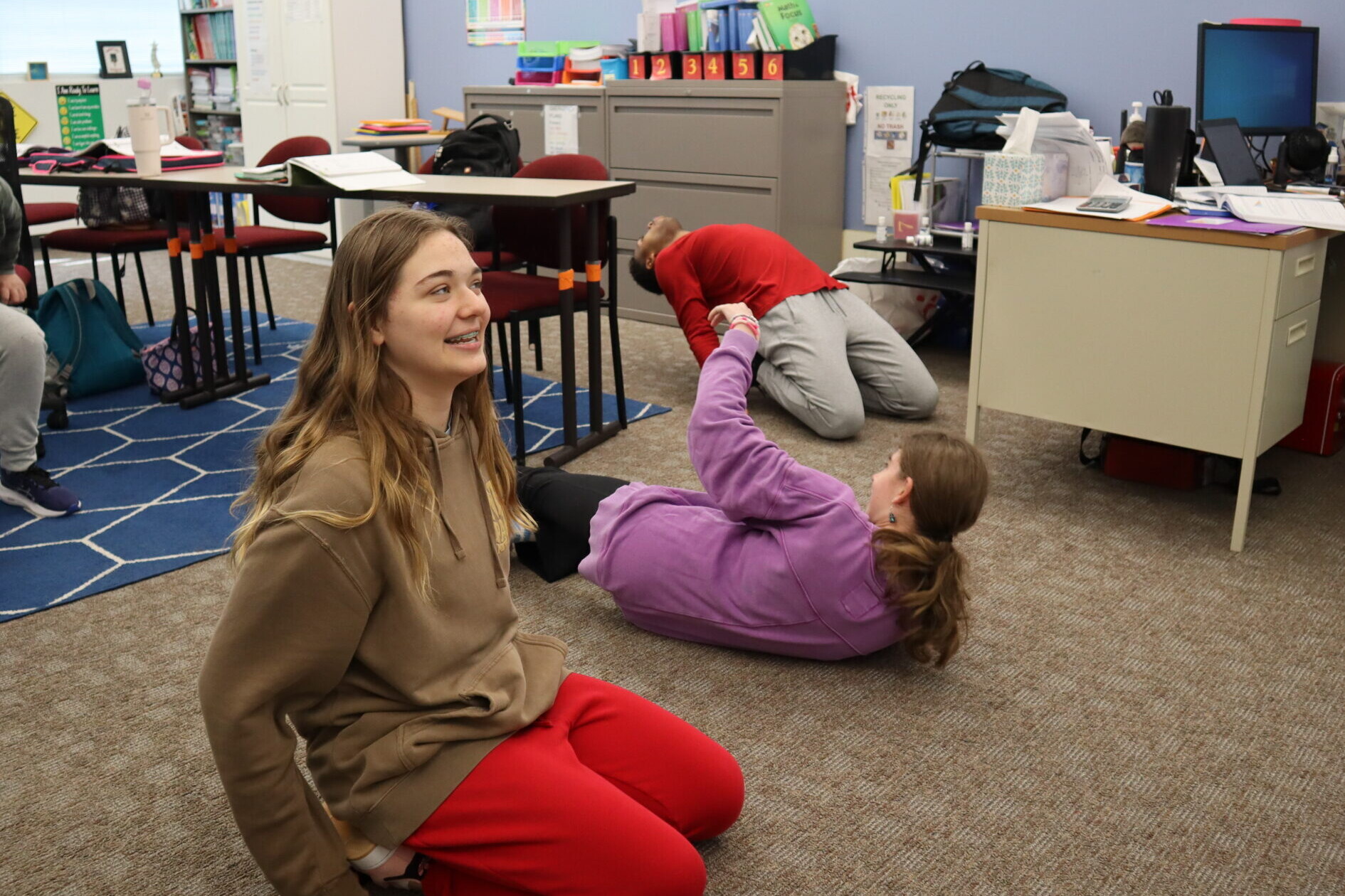 Students in math class take a movement break during class.
