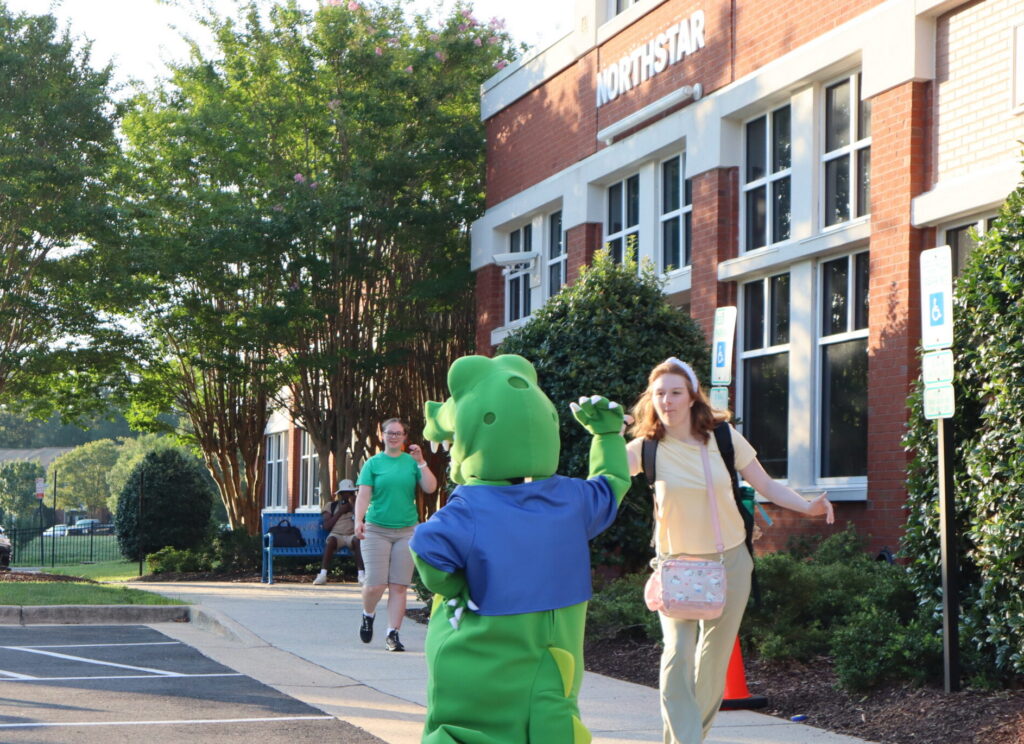 Mascot High Five A student high fives Northstar's mascot Navi the Gator.